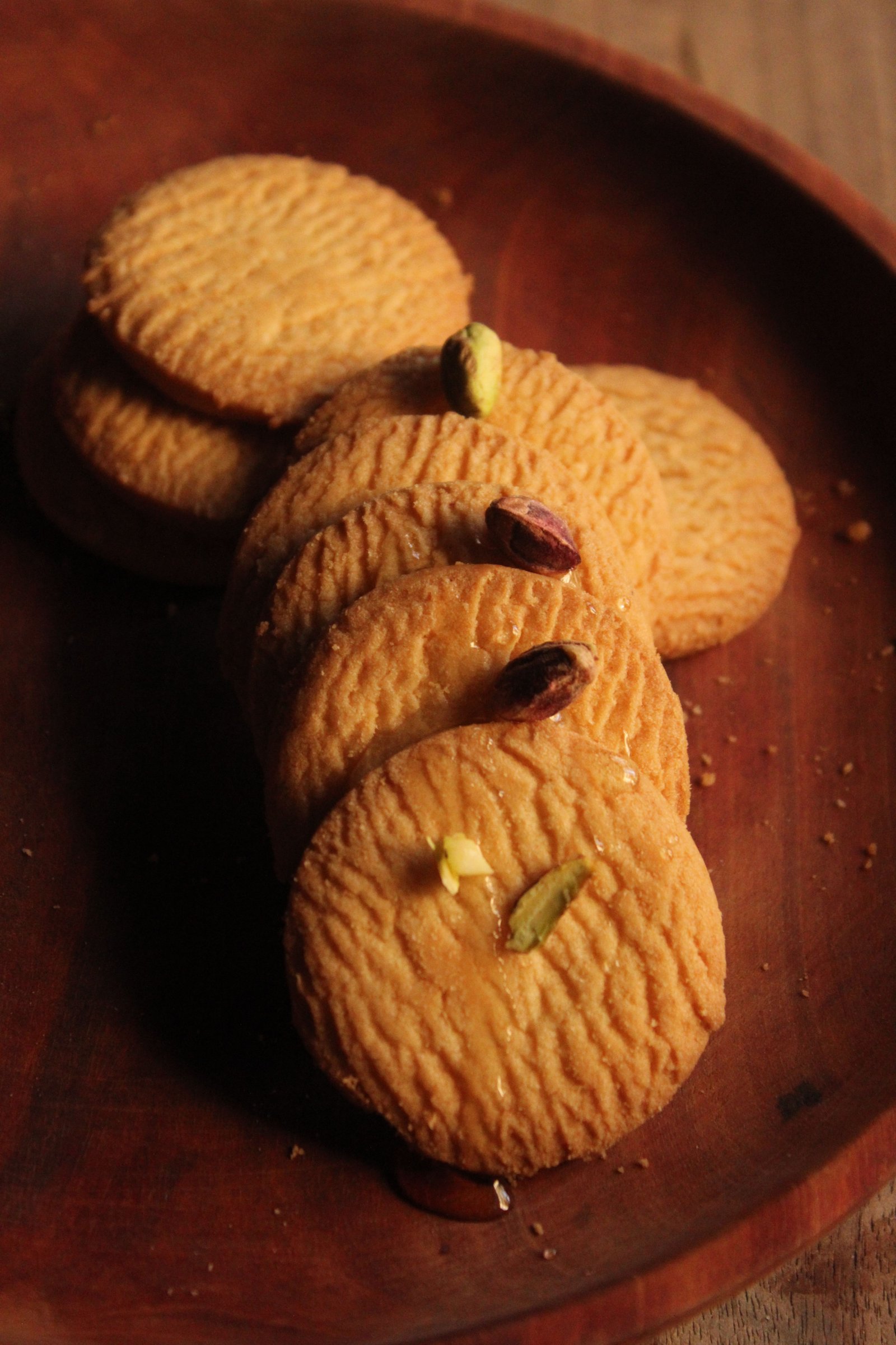Osmania biscuits stacked beside a cup of tea